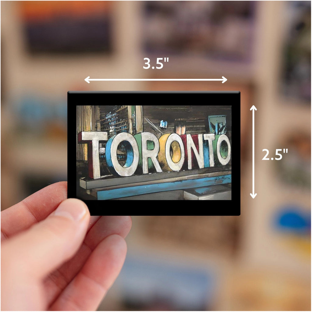 Person holding Toronto Sign Fridge Magnet.
