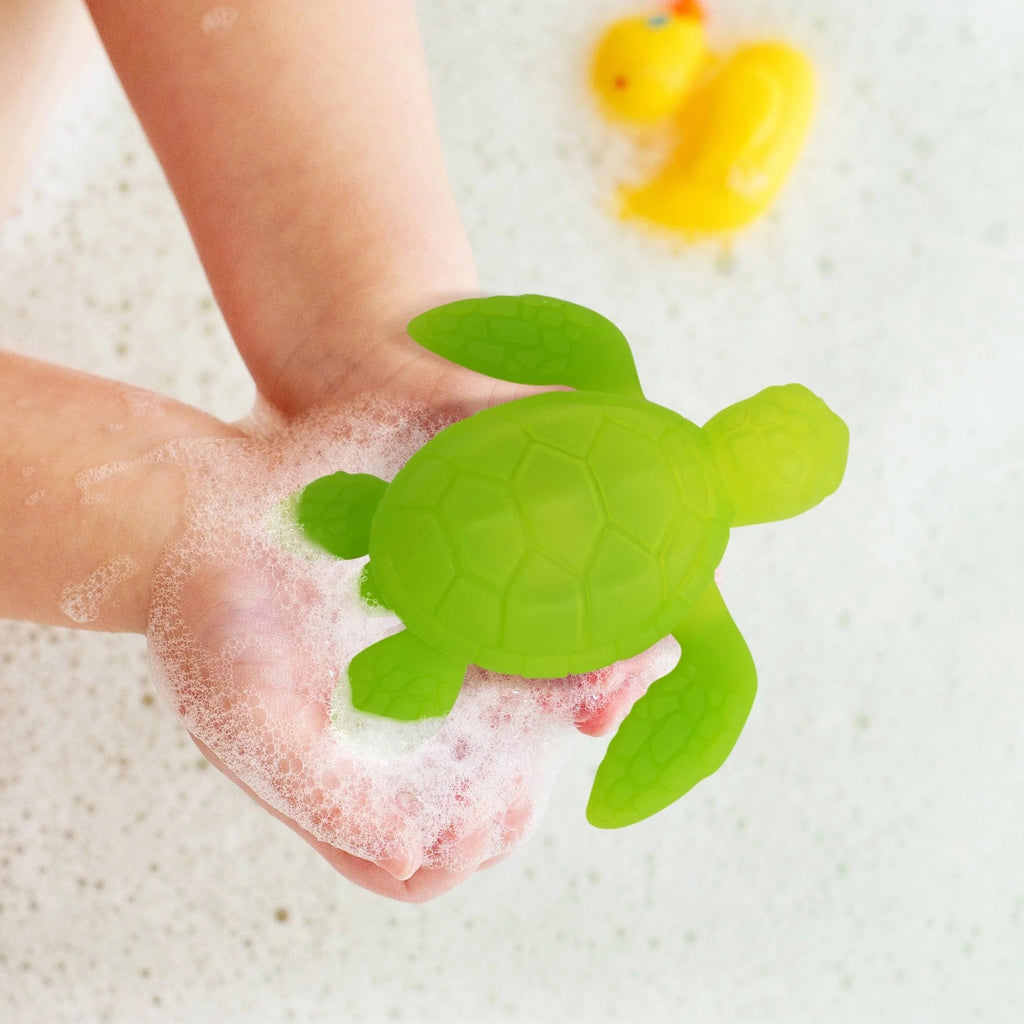 Person holding Tub Turtle Light Up Bath Toy.