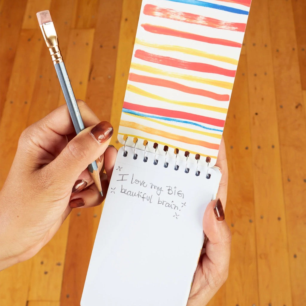 Person using Busy Day Spiral Notebook.