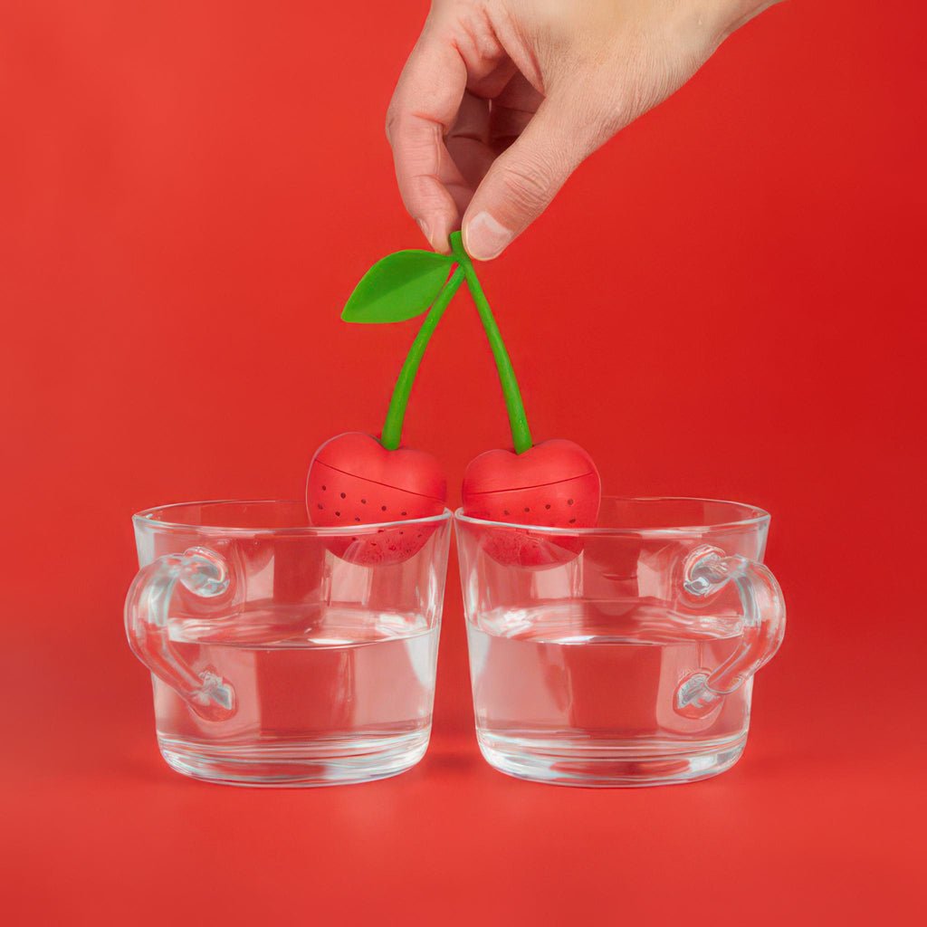 Person using Cherry Double Tea Infuser.
