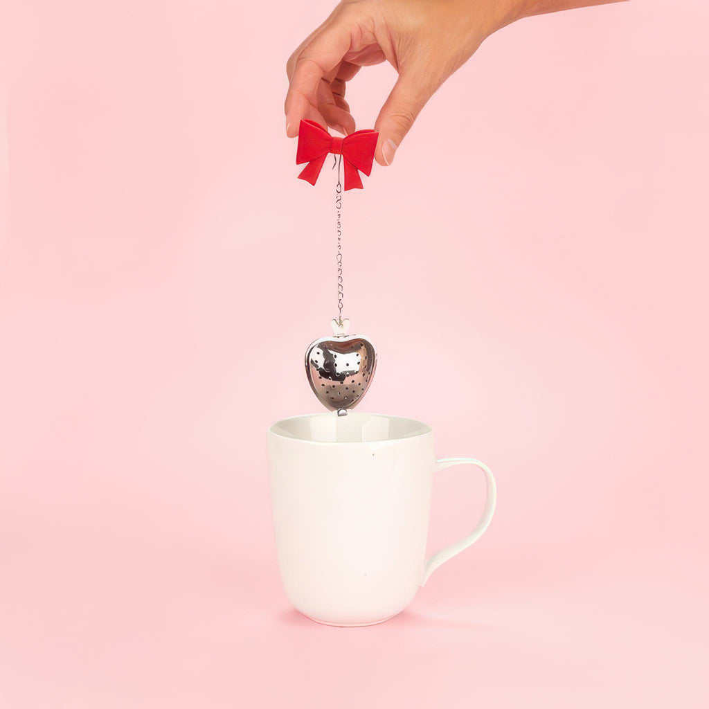Person using Coquette Tea Infuser.