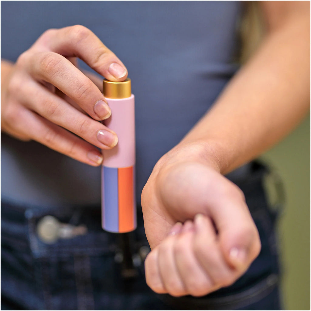 Person using Inkerie Perfume Atomizer.