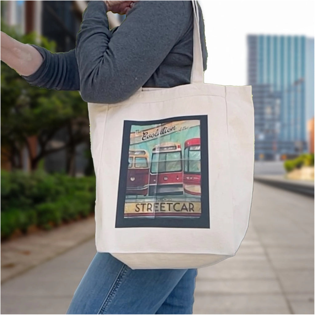 Person using Toronto Evolution Of The Streetcar Tote Bag.