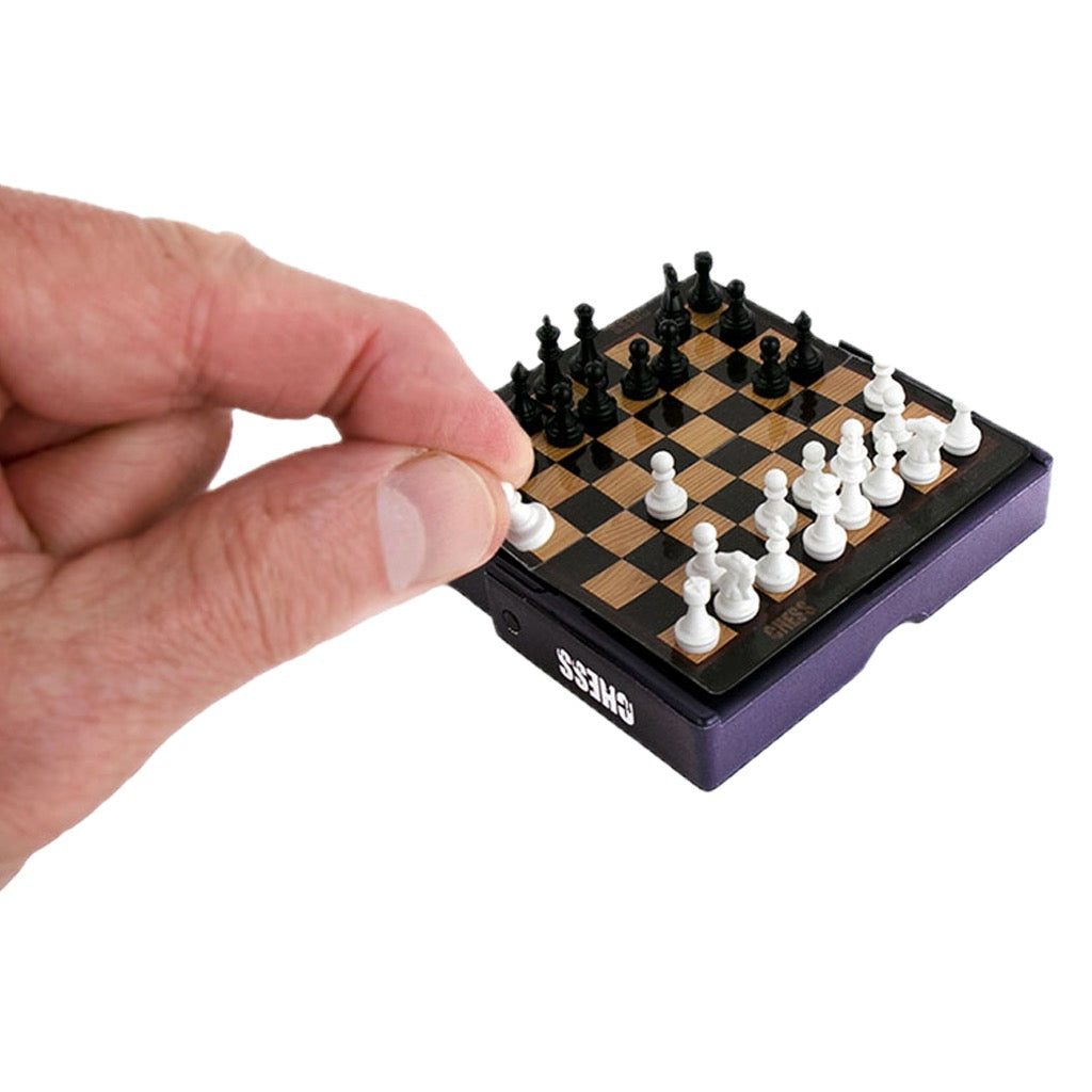 Person using World's Smallest Chess Game.