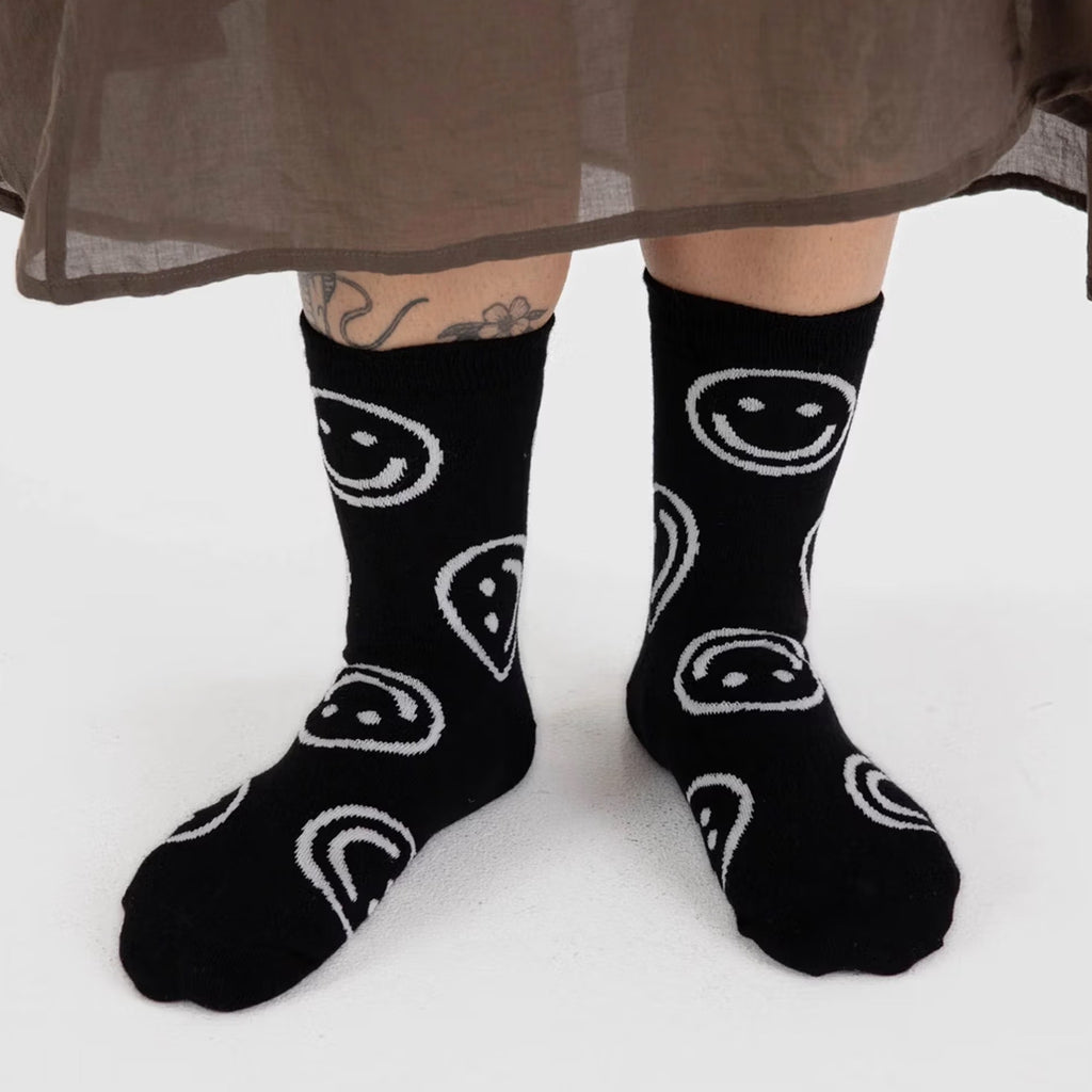 Person wearing Black Happy Face Crew Socks.