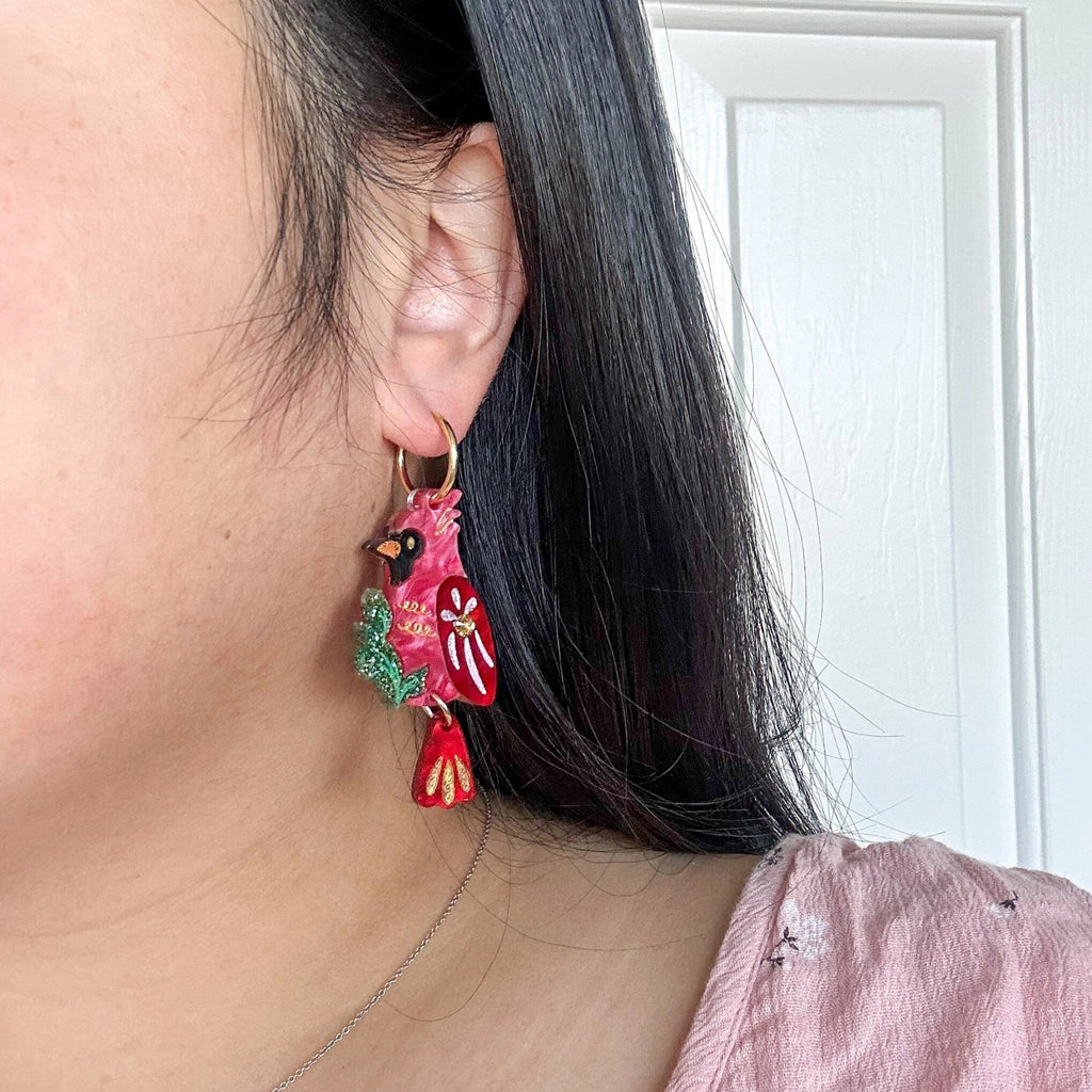 Person wearing Cardinal Earrings.