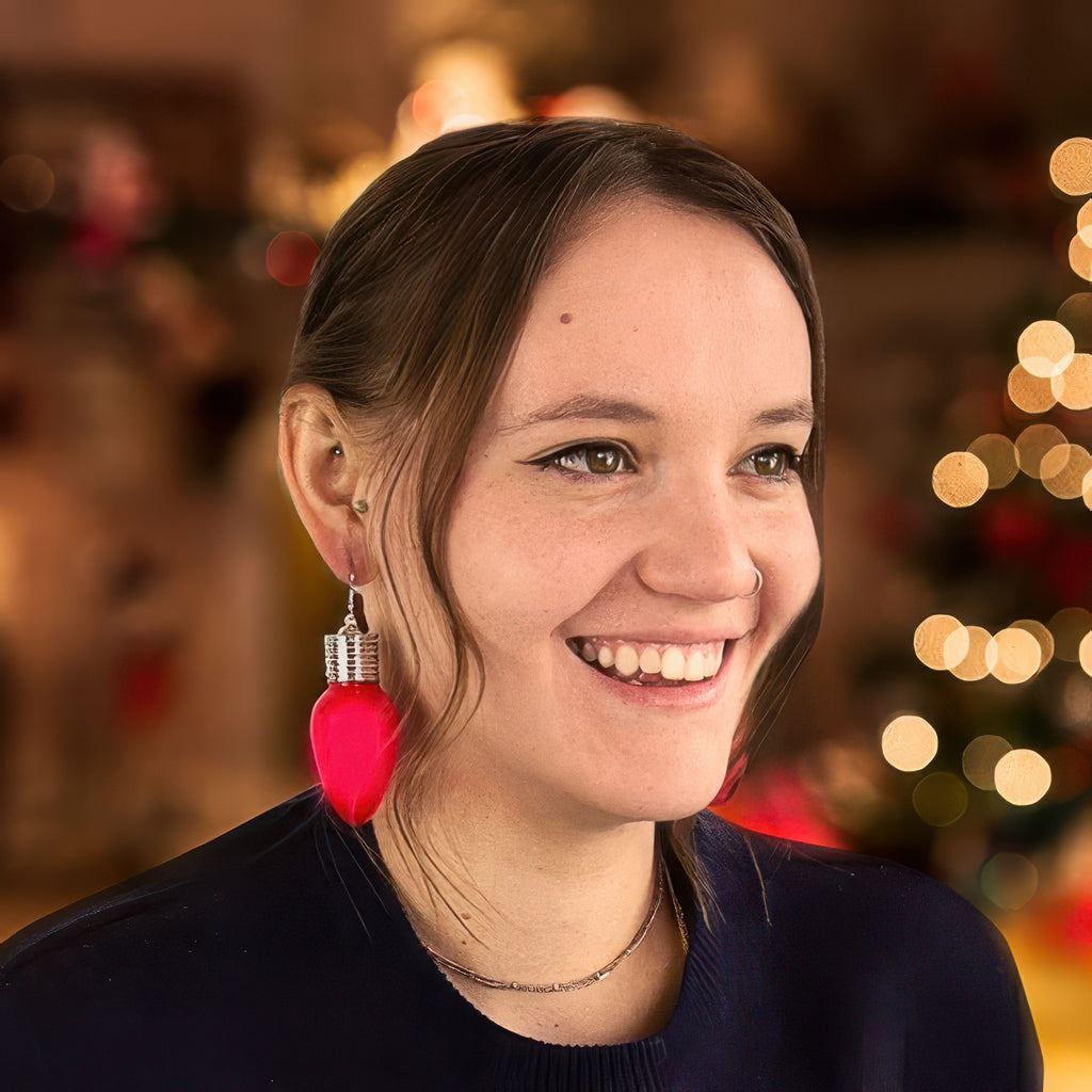 Person wearing Christmas Lght Up Earrings.