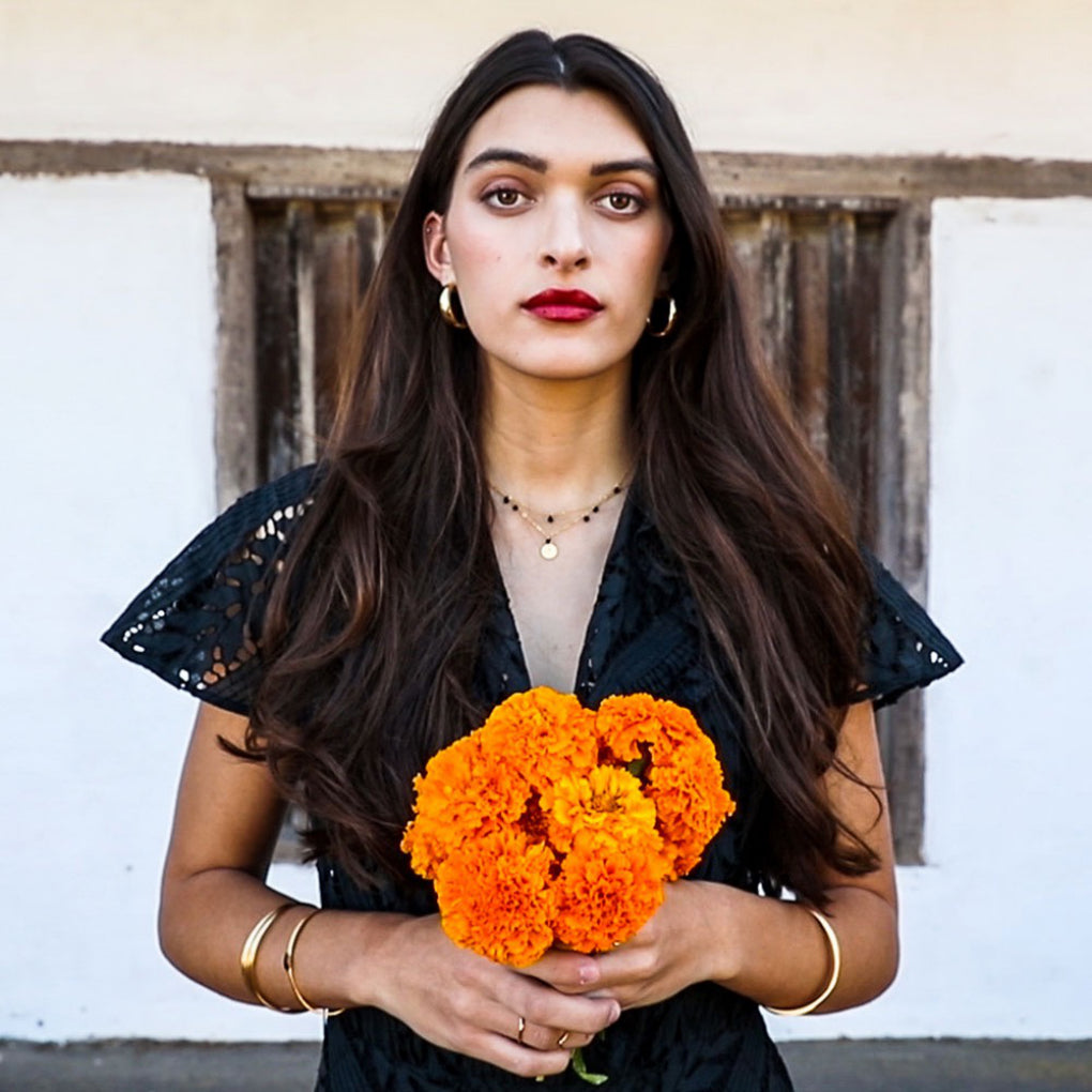 Person wearing Five Graces Black Necklace and another necklace.