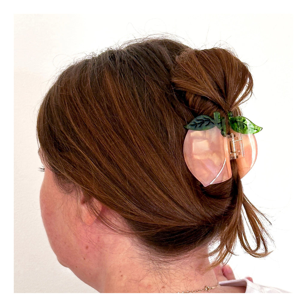 Person wearing Midi Peach Hair Claw Clip.