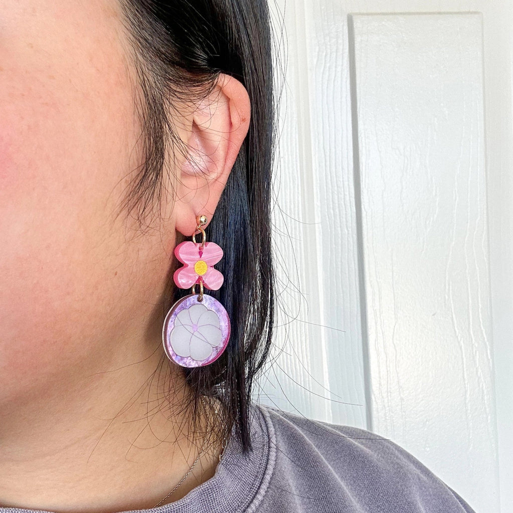 Person wearing Mismatch Mangosteen Dangle Earrings.