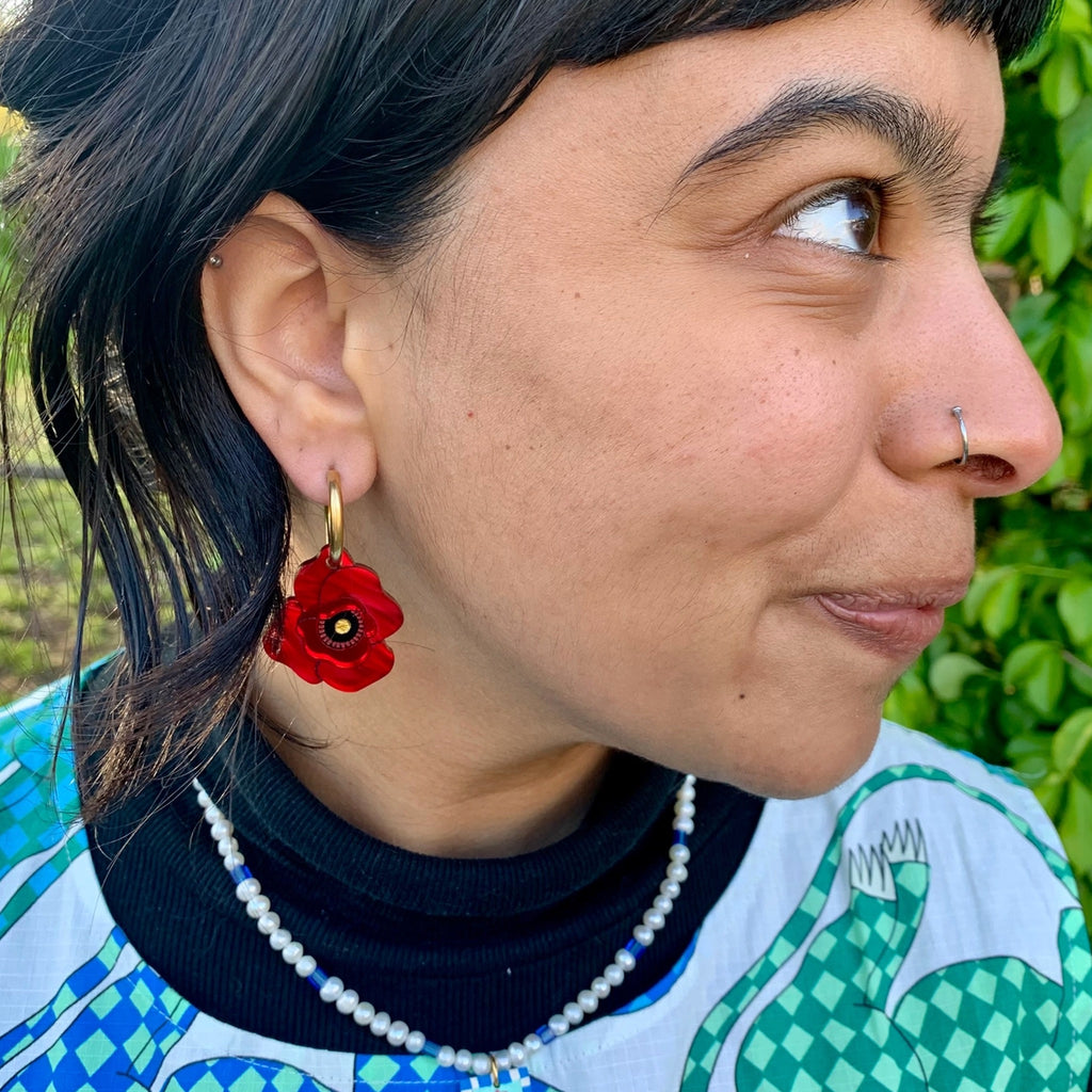 Person wearing Poppy Flower Earrings.