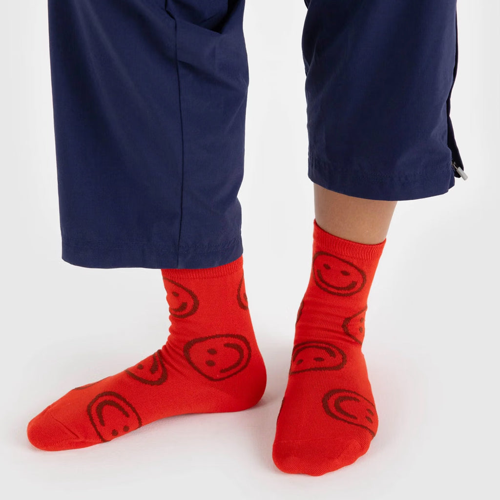 Person wearing Red Happy Face Crew Socks.