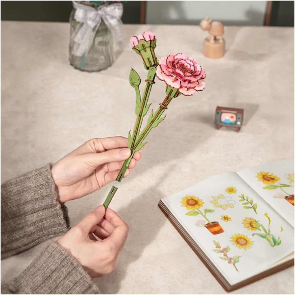 Pink Carnation 3D Wooden Flower Puzzle in hand.