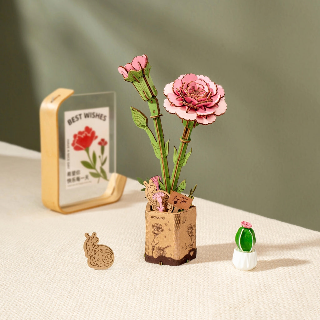 Pink Carnation 3D Wooden Flower Puzzle on table.