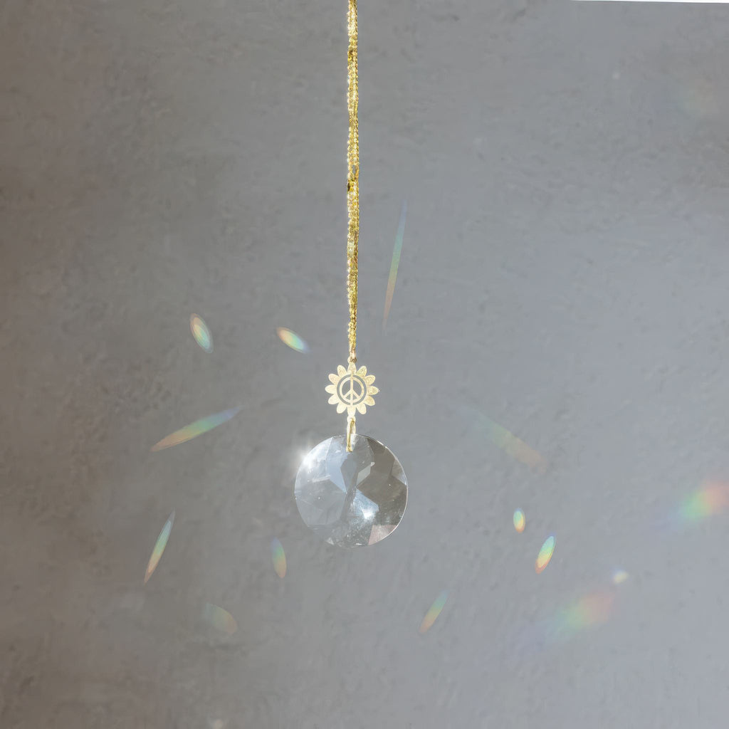 Pocket Suncatcher Peace Flower in window.