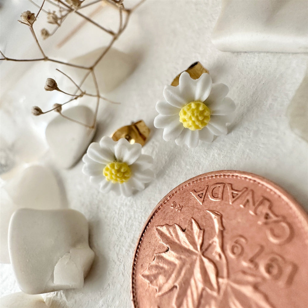Porcelain Daisy Stud Earrings White besides penny.