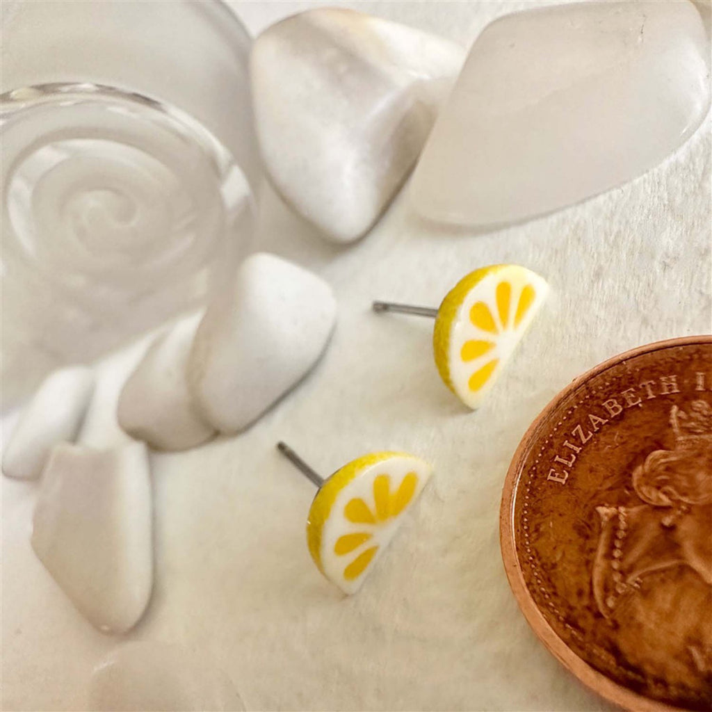 Porcelain Lemon Slice Stud Earrings besides penny.