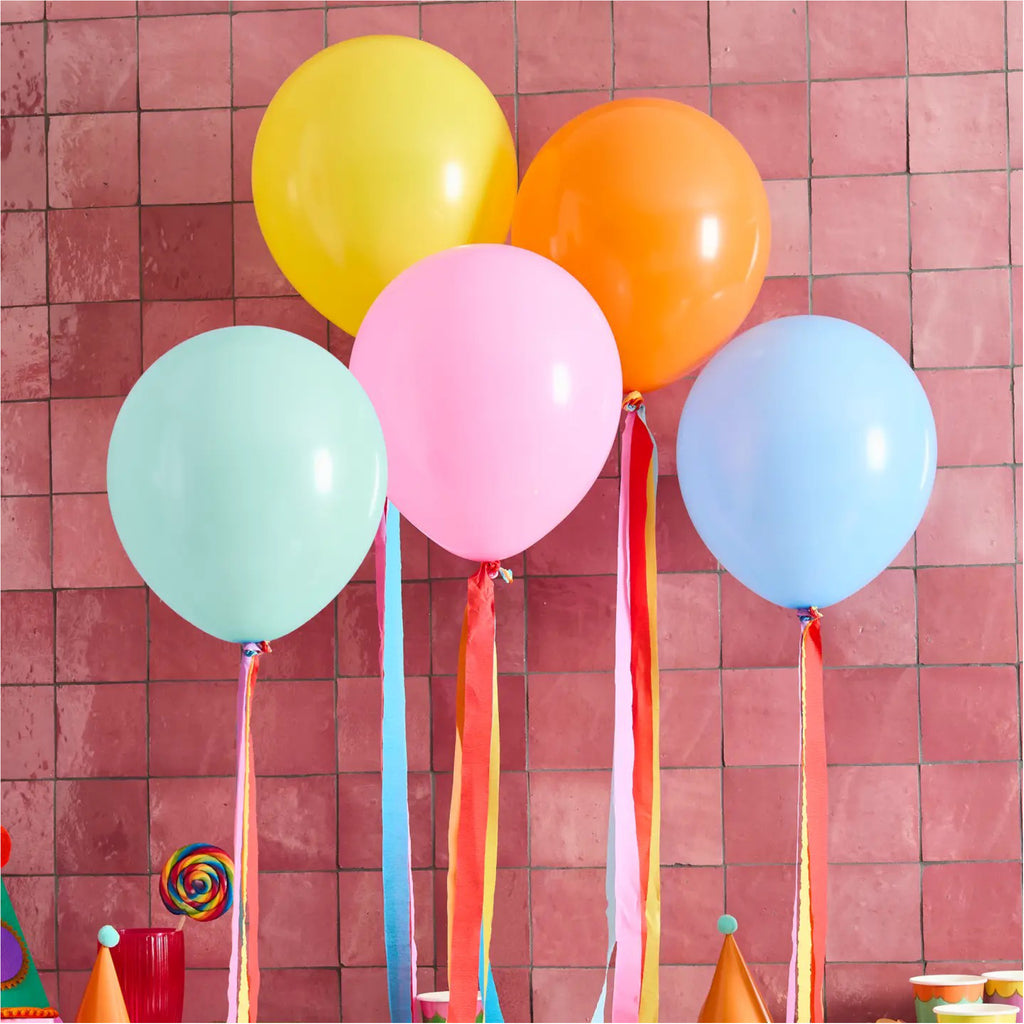 Premium Bright Latex Balloons & Tassel Tails against wall.
