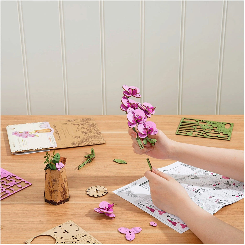 Purple Moth Orchid 3D Wooden Flower Puzzle being assembled.