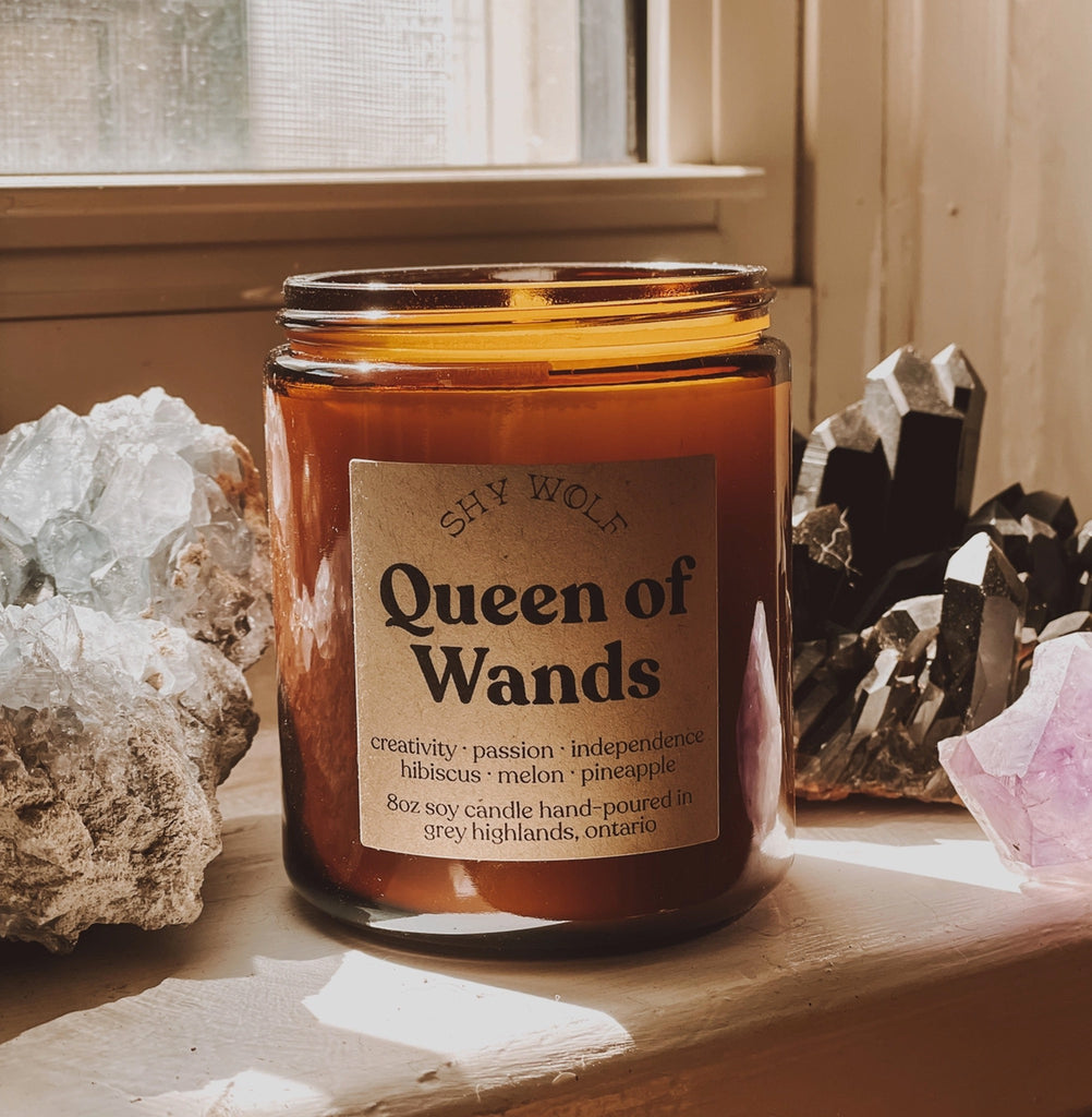 Queen Of Wands Tarot Soy Wax Candle on ledge.