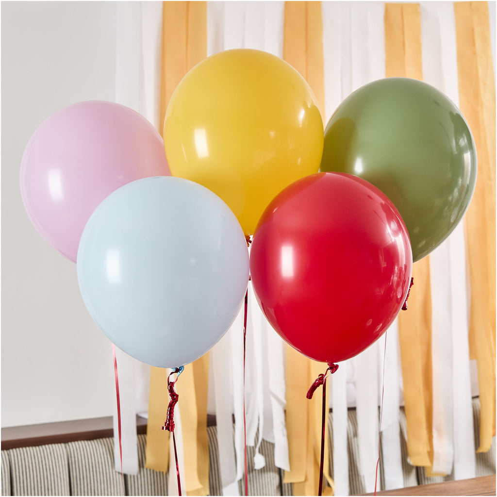 Rainbow Circus Latex Balloons Pack Of 5 against wall.