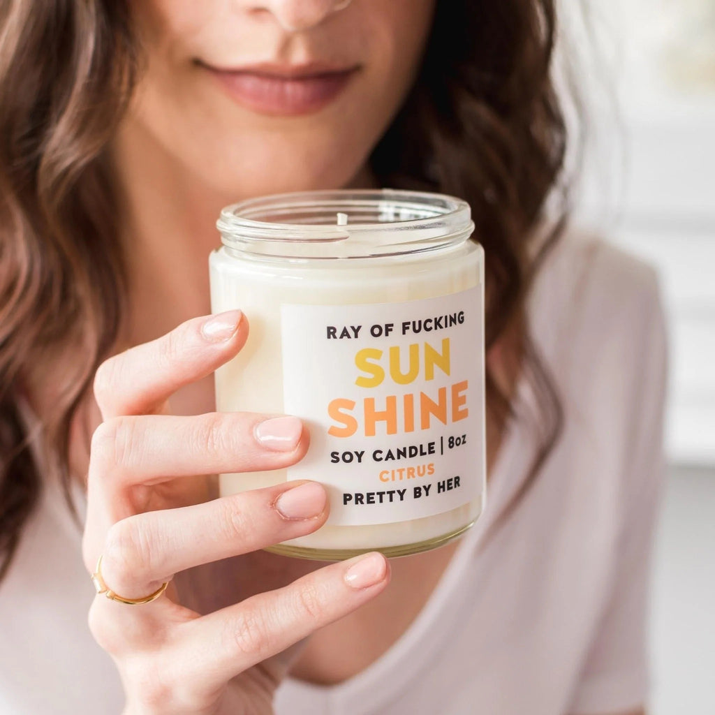 Ray Of Fucking Sunshine Soy Wax Candle being held.