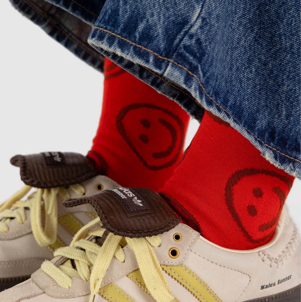 Red Happy Face Crew Socks in shoes.