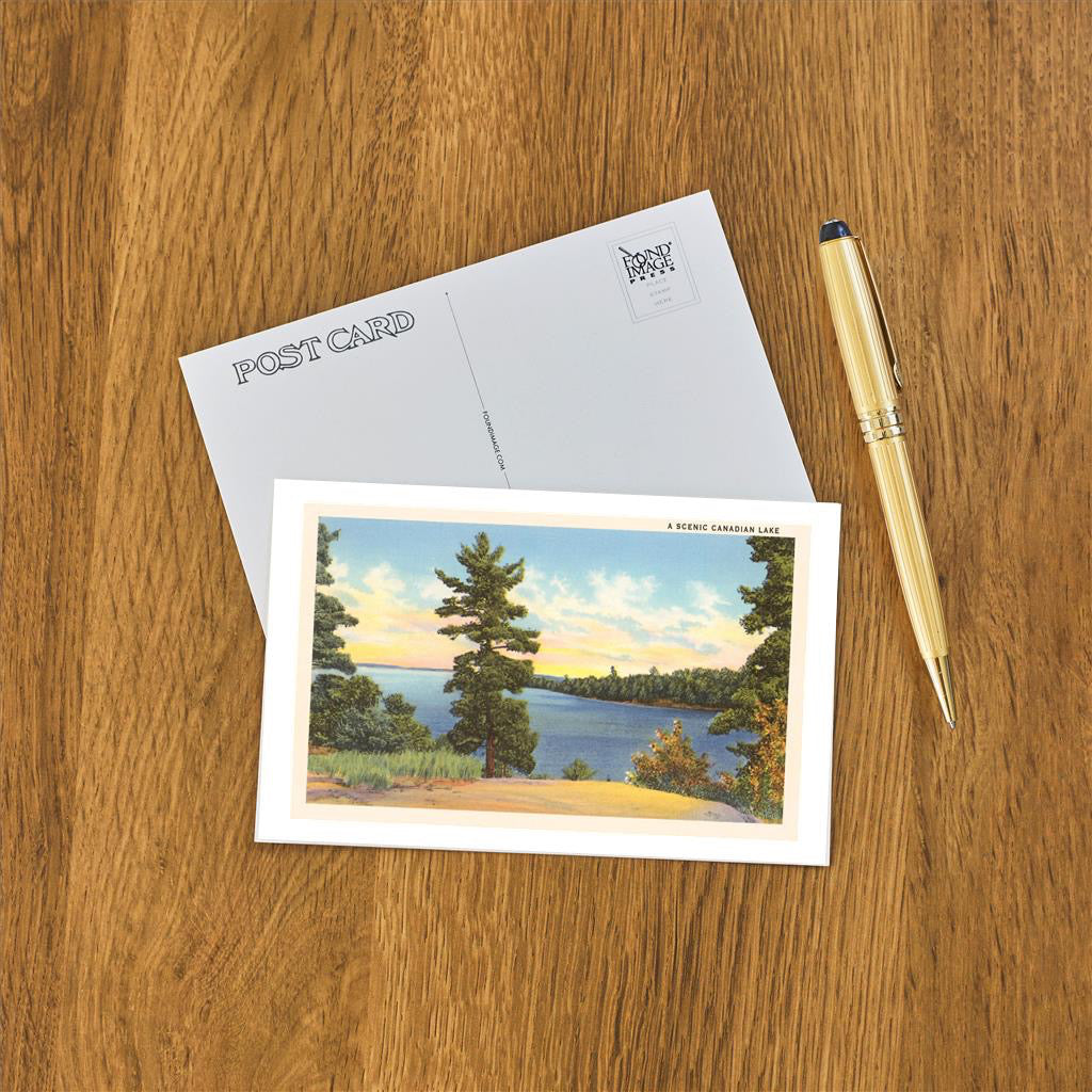 Scenic Canadian Lake Postcard on table.