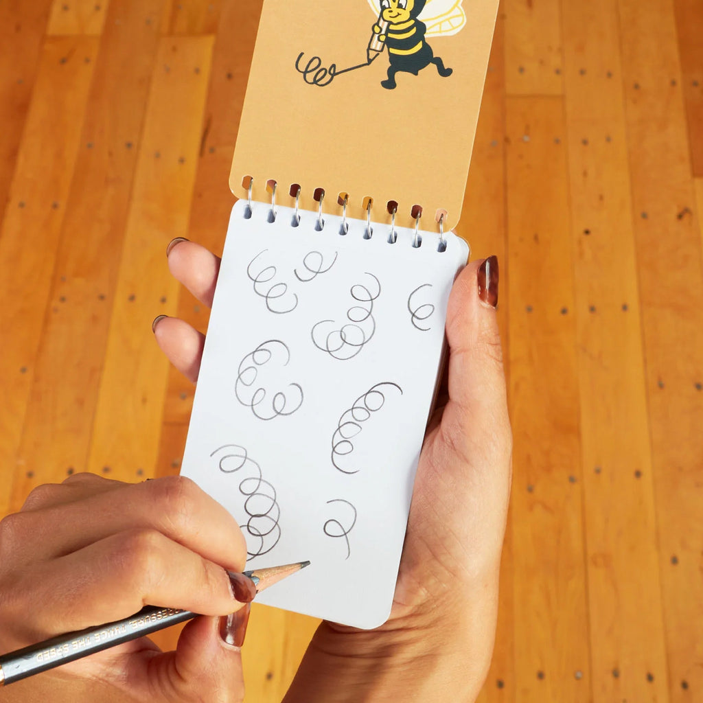 Silly Dumb Shit Spiral Notebook being used.