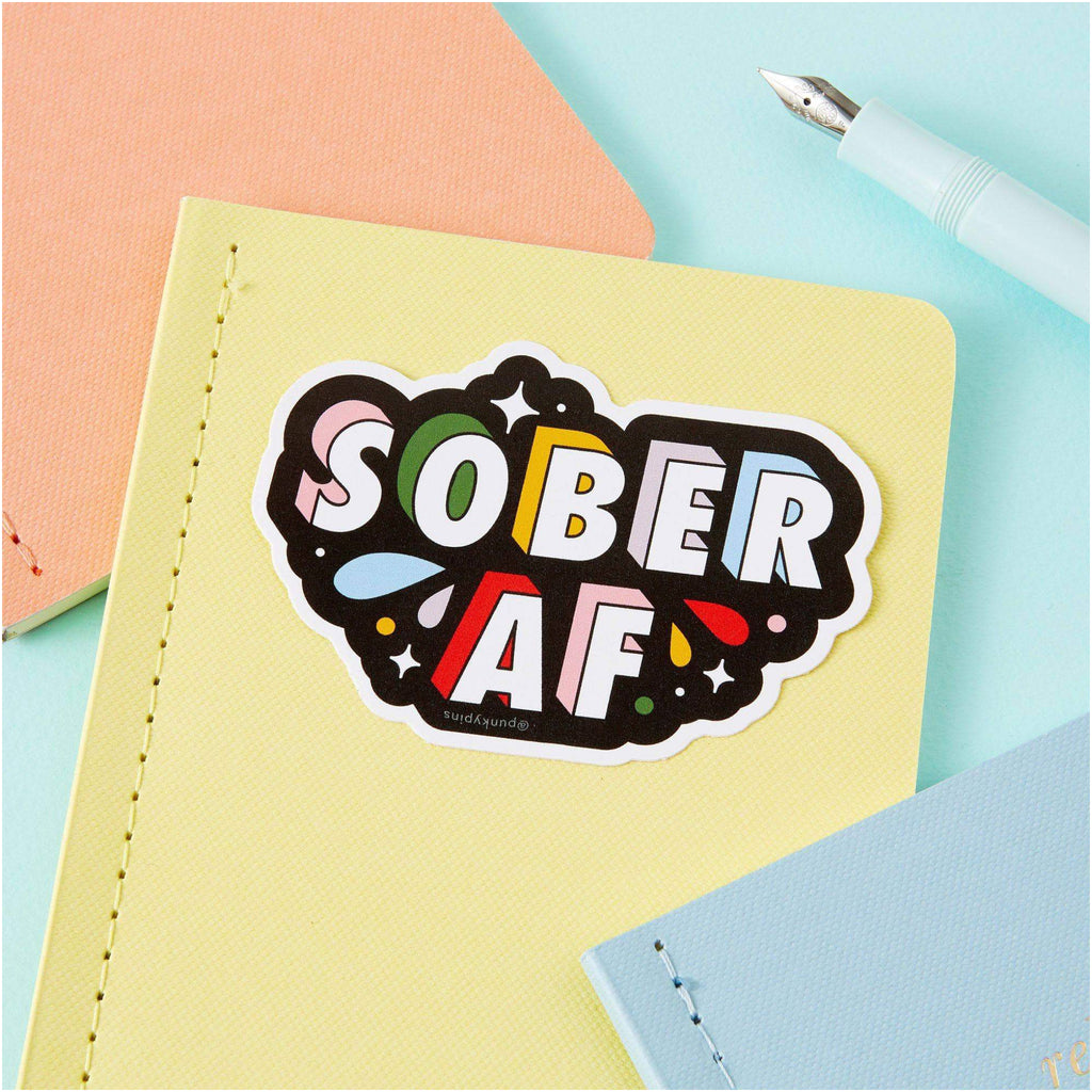 Sober AF Vinyl Sticker on book.