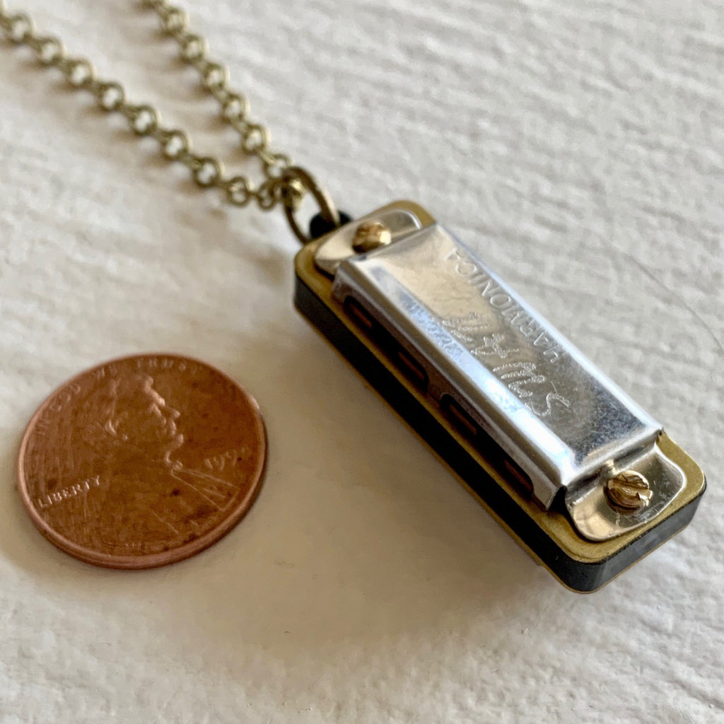 Swan Harmonica Necklace besdies a penny.