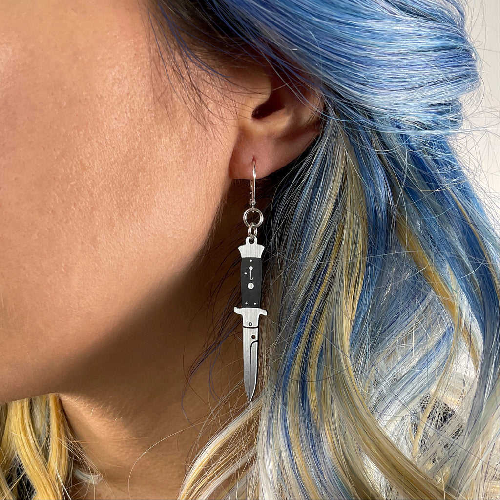 Switchblade Hook Earrings Person wearing.