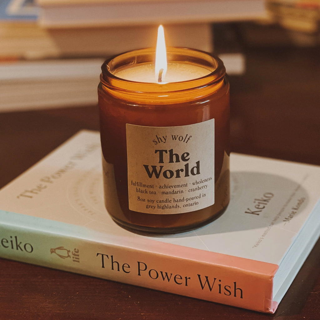 The World Tarot Soy Wax Candle on table.