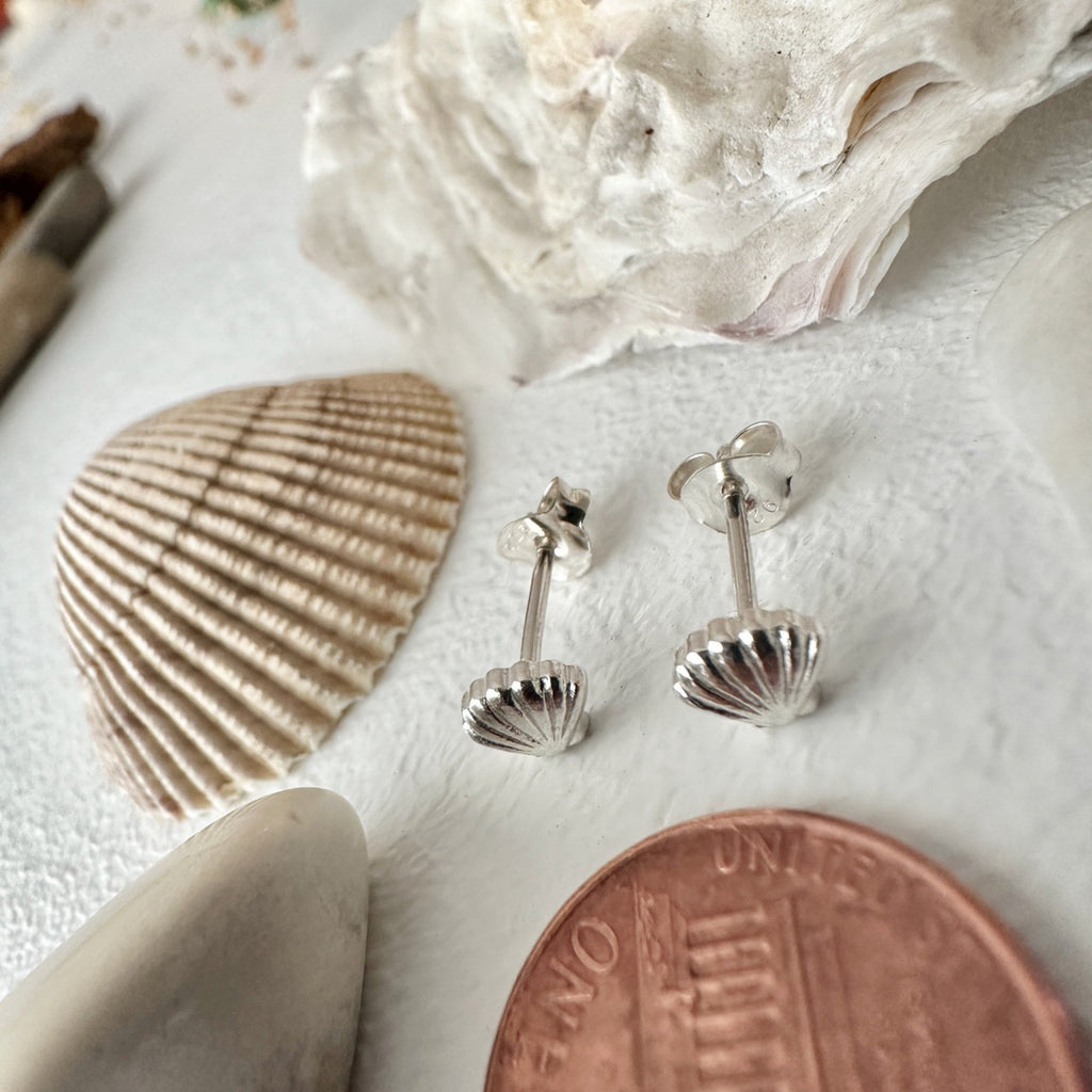 Tiny Shell Stud Earrings Sterling Silver besides a penny.
