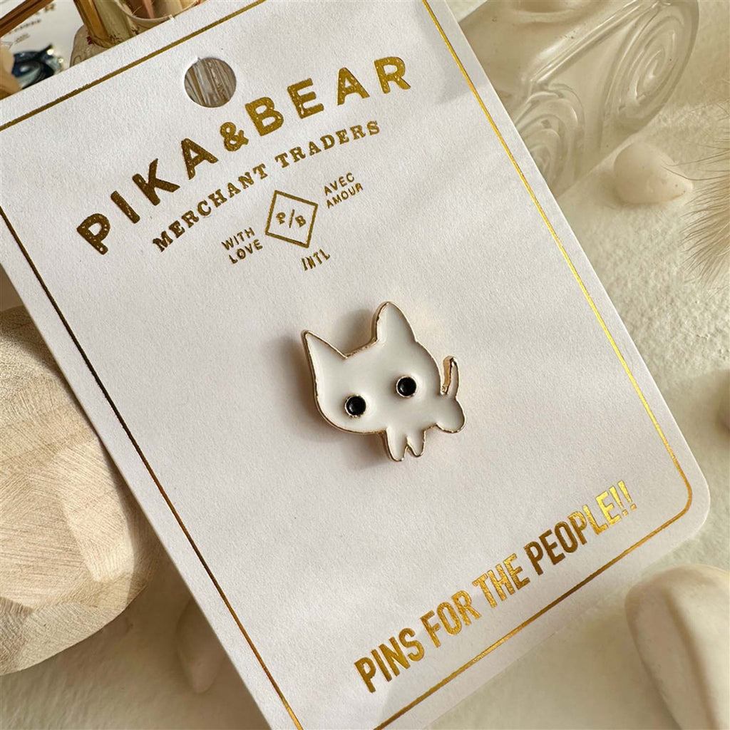 Tiny Timid Cat Enamel Pin packaging.