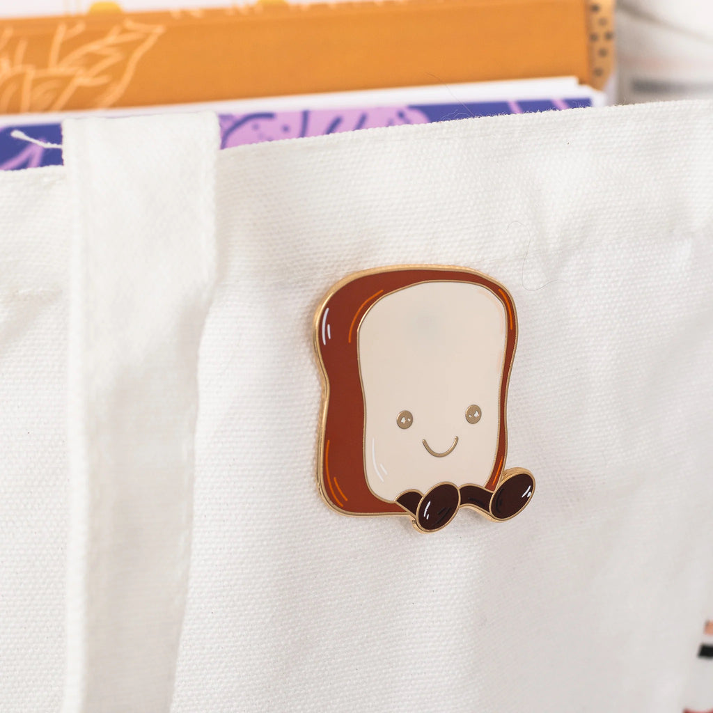 Toast Enamel Pin on bag.