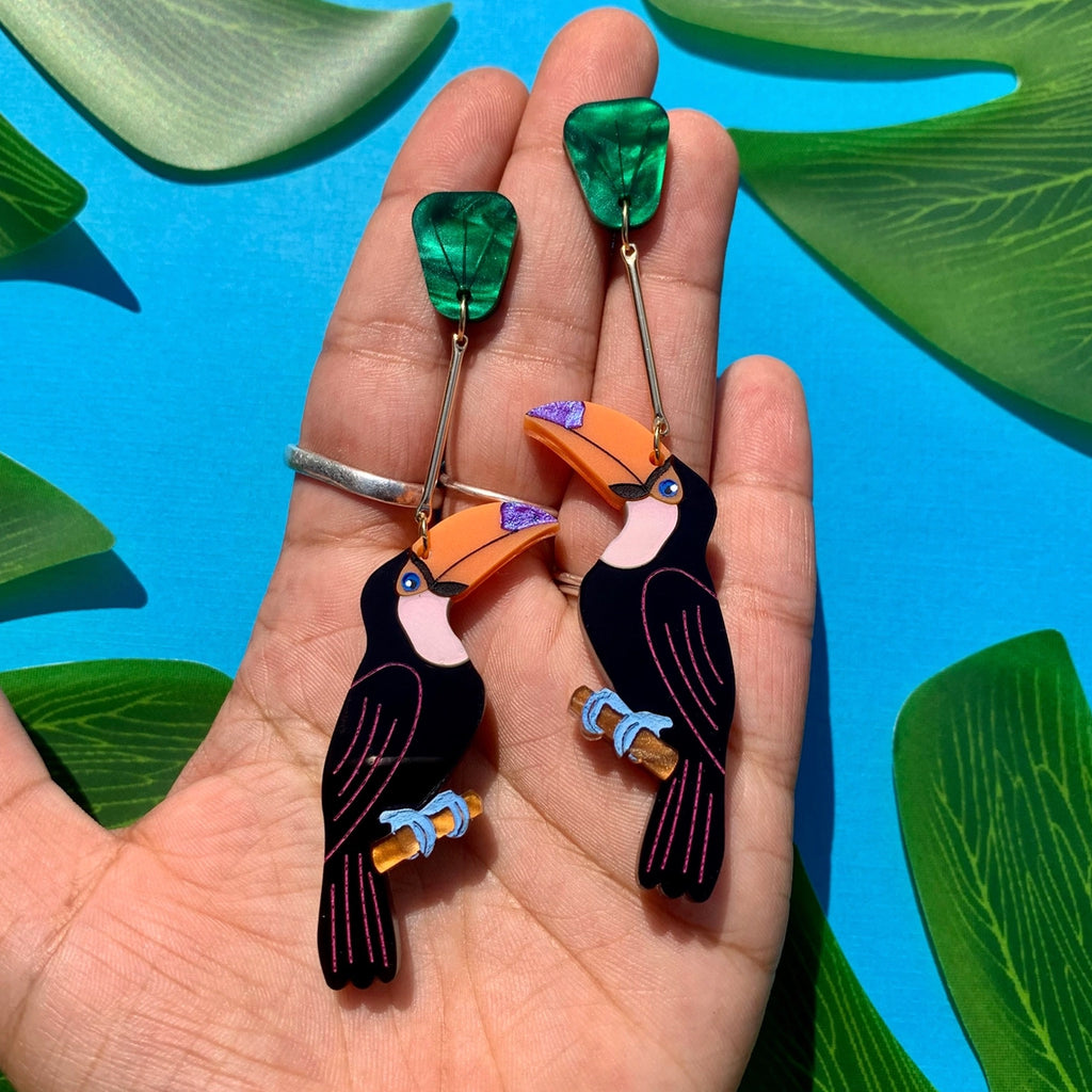 Toucan Earrings in hand.