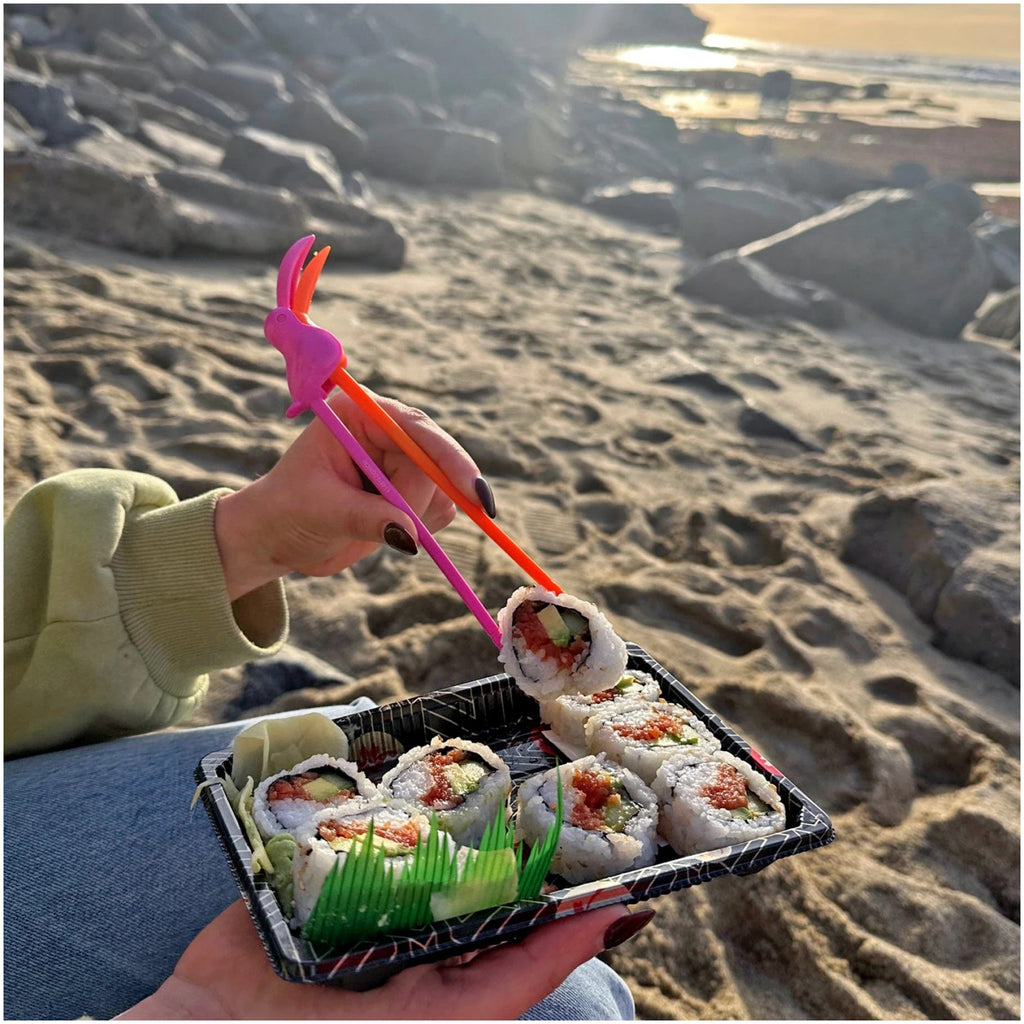 Toucan Munchtime Chopsticks on beach.