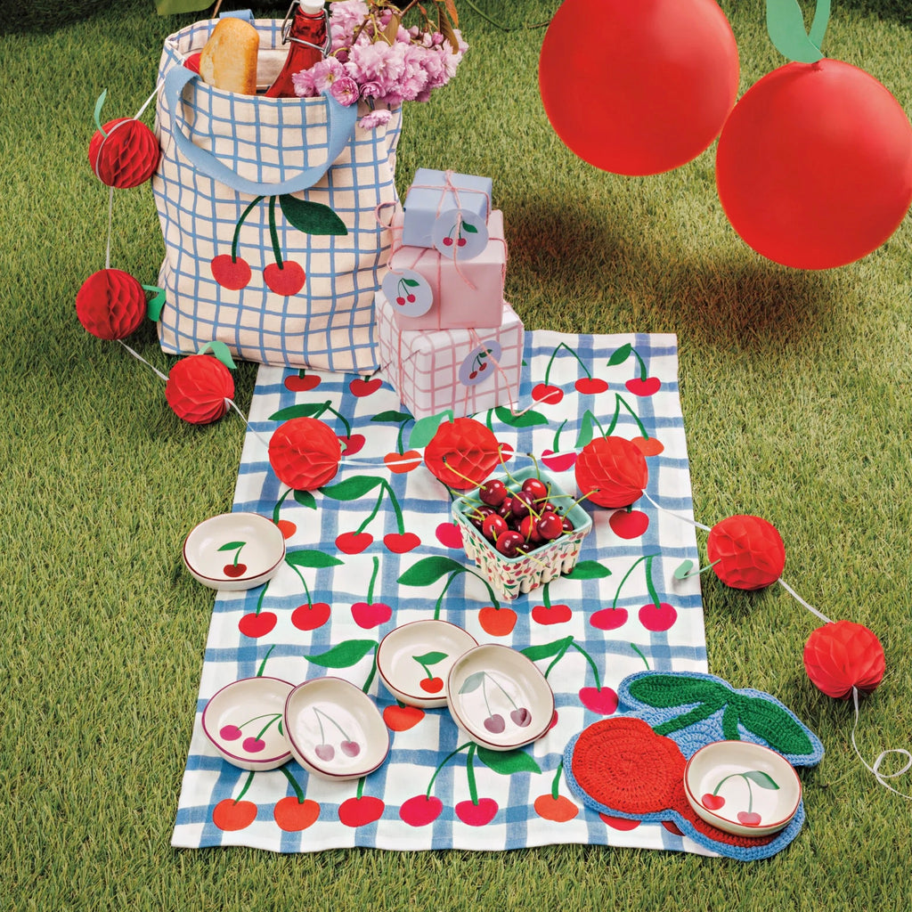 Very Cherry Printed Dishtowel on grass.