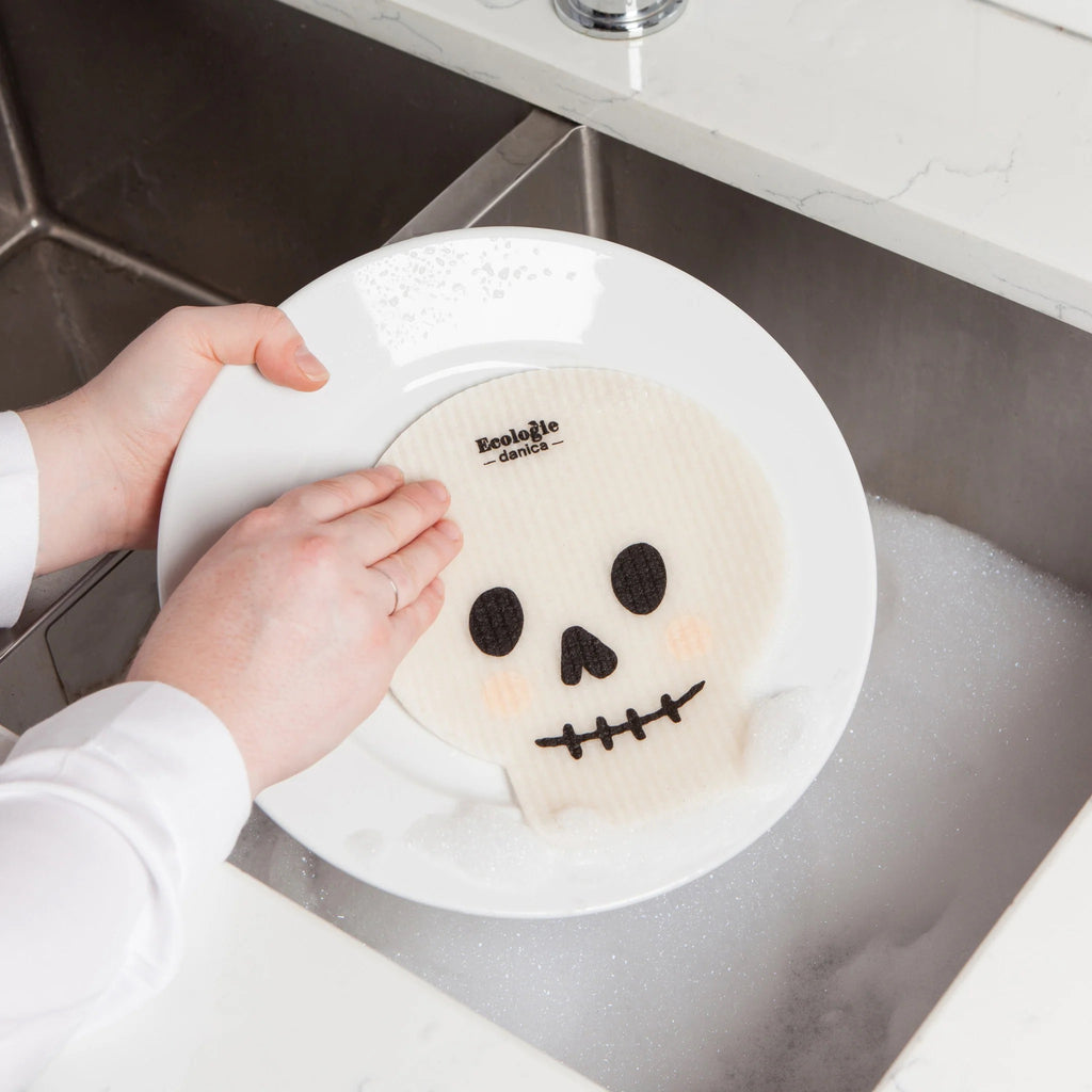 Washing dishes with a Boo Crew Skull Swedish Sponge Cloth.