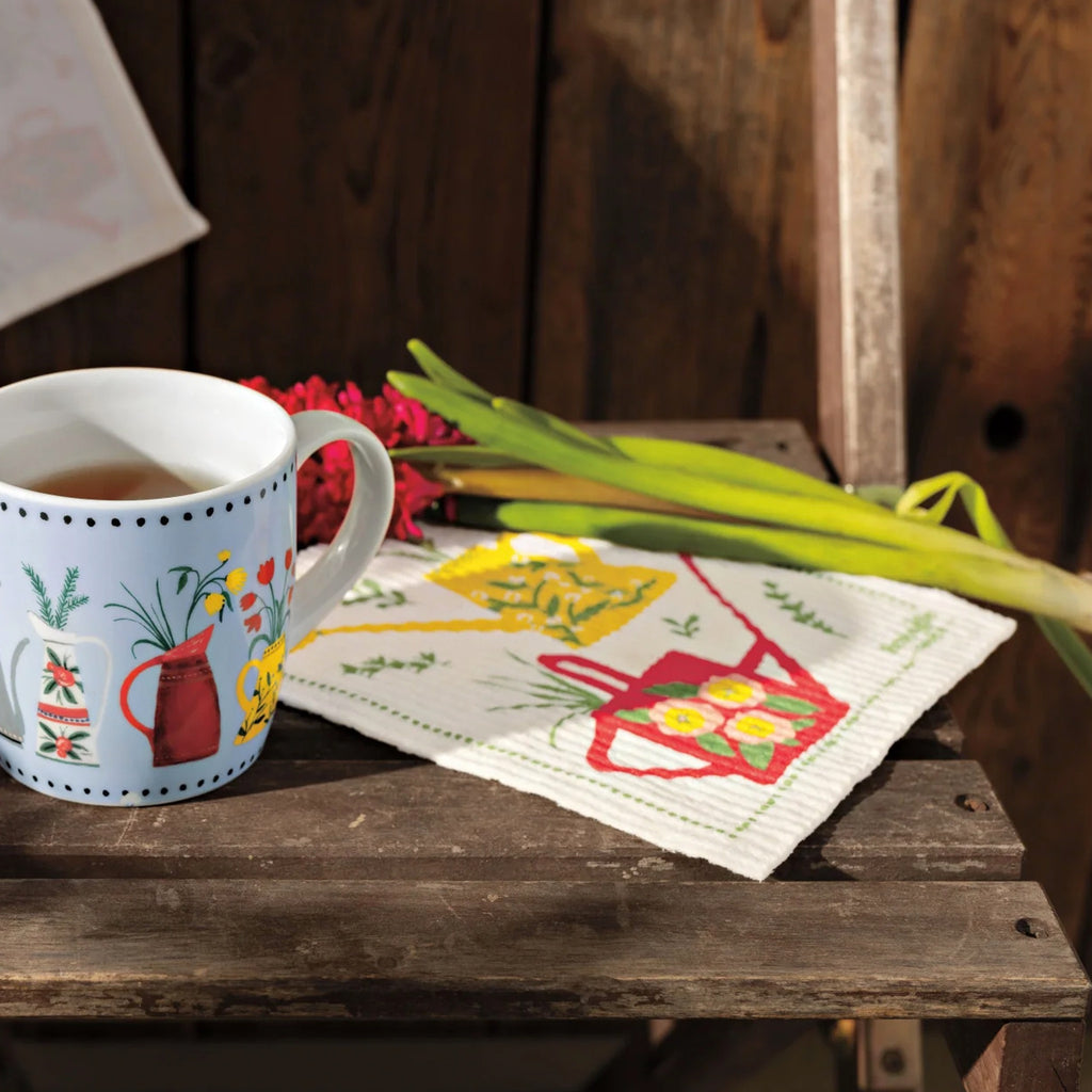 Watering Cans Printed Dishtowel on table.