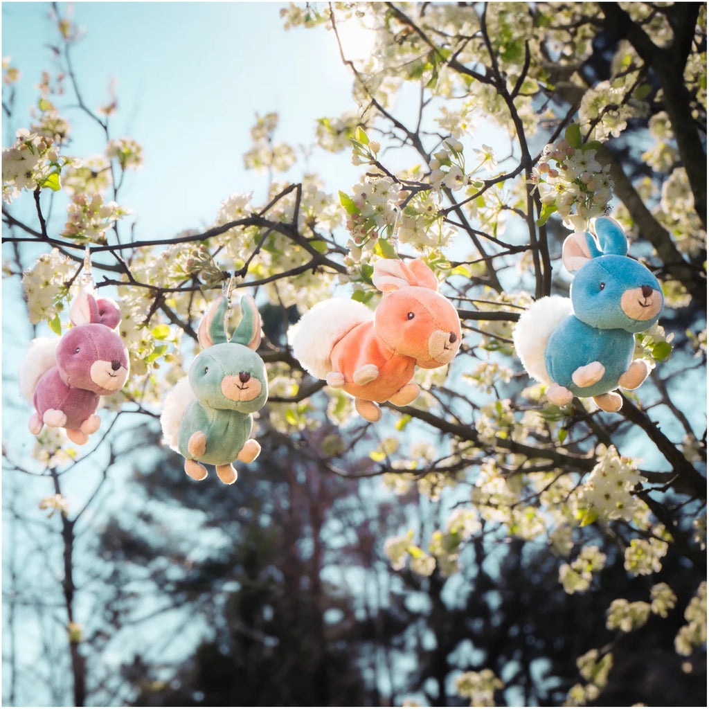 Zeus Bunny Bag Charm Orange in tree.