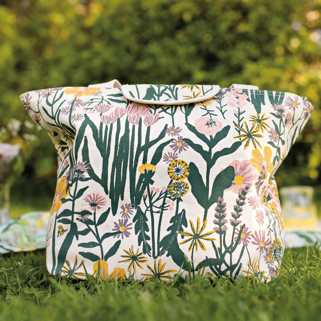 Bees & Blooms Fold-Up Fresh Tote on grass.