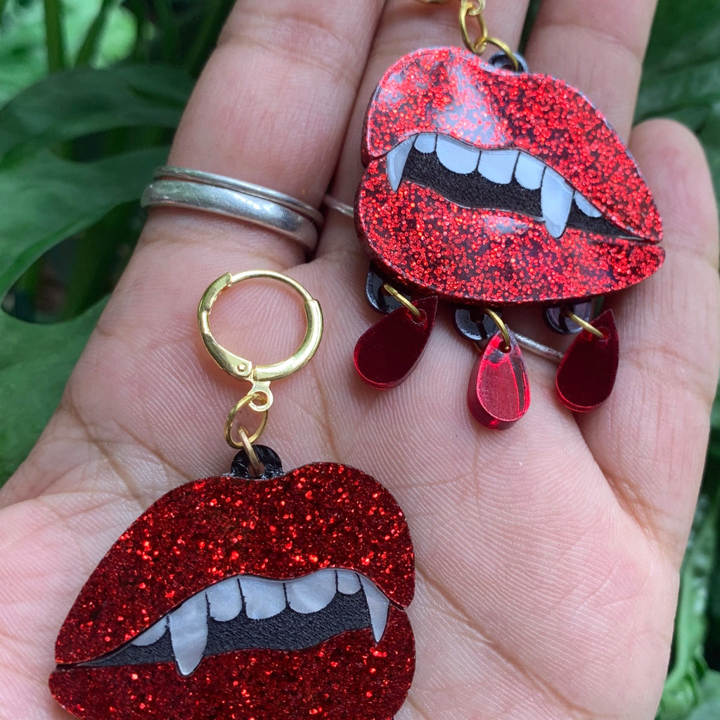 Blood Sucker Earrings in hand.