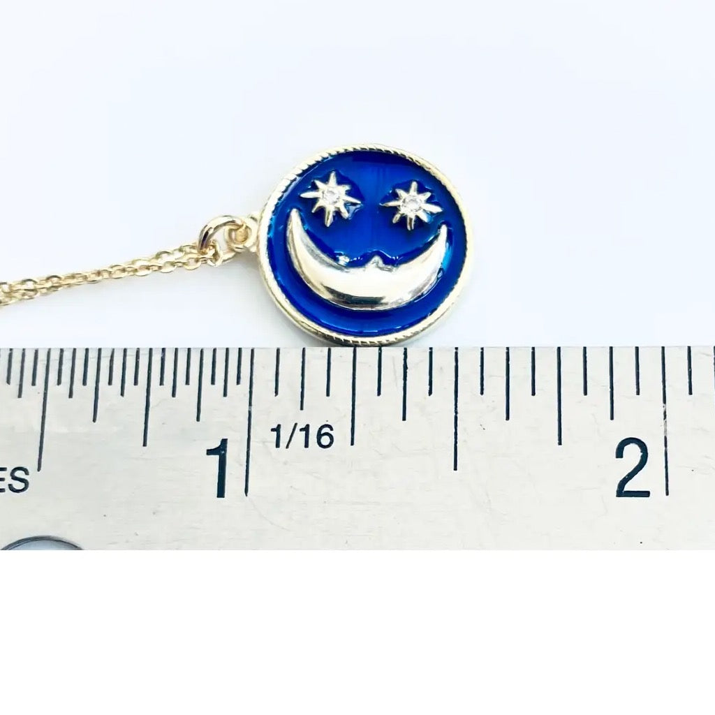 Blue Enamel Moon Necklace on ruler.