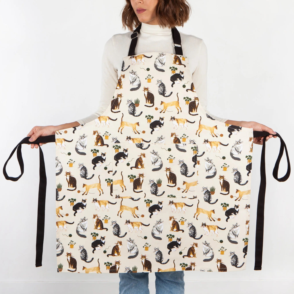 Cat Collective chef apron being held wide.