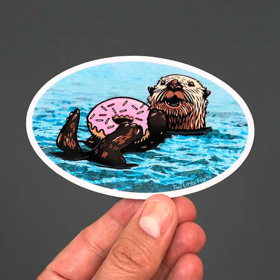 Doughnut Sea Otter Sticker hand holding.