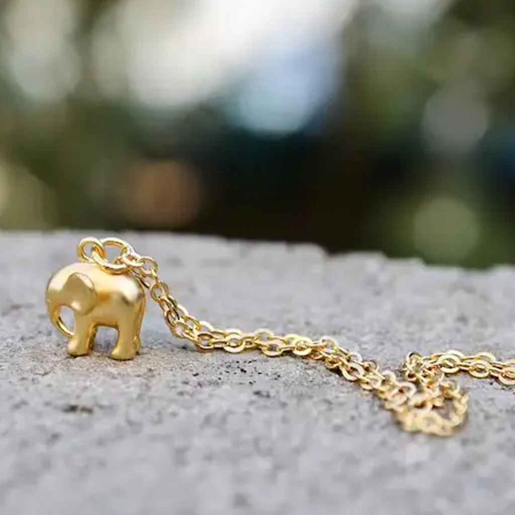 Elephant Necklace with elephant standing on rock.