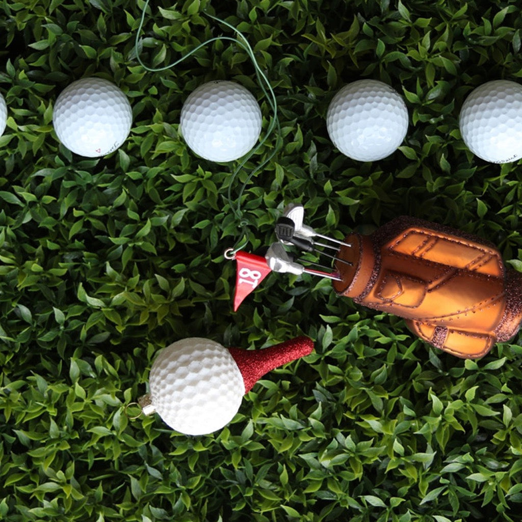 Golf Ball On Tee Ornament on fake grass.