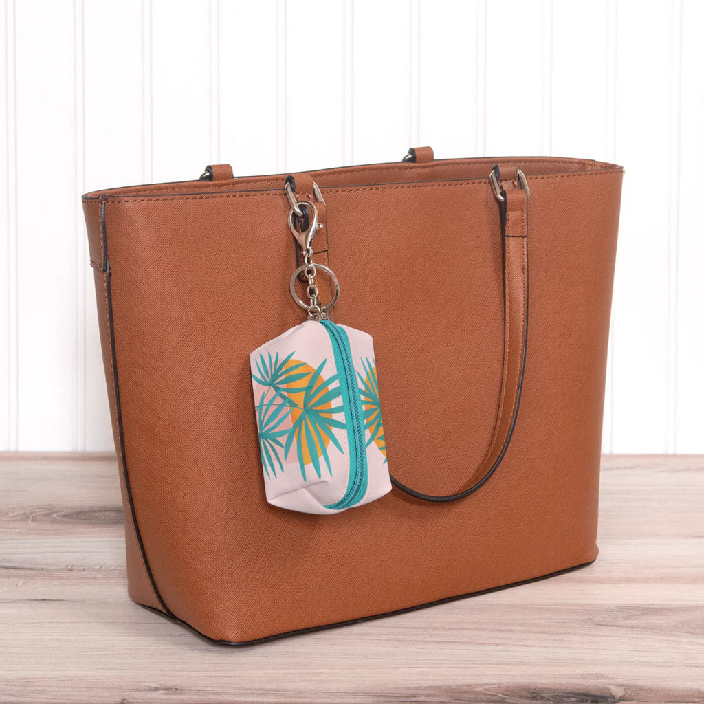 Island Sunset Key Chain Pouch hanging on purse.